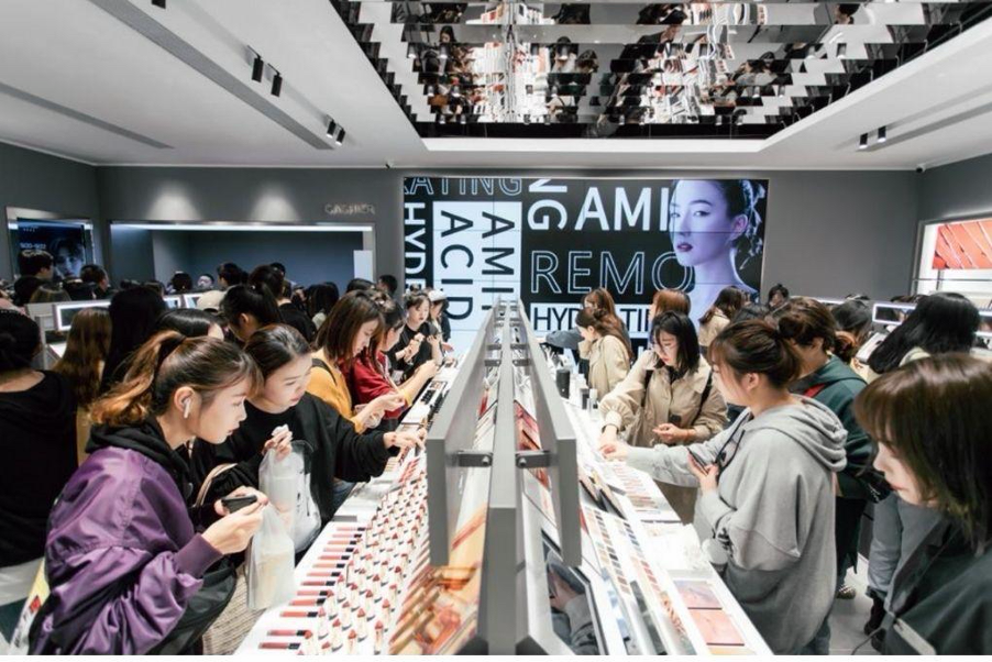 Shoppers browsing a busy beauty store counter in China