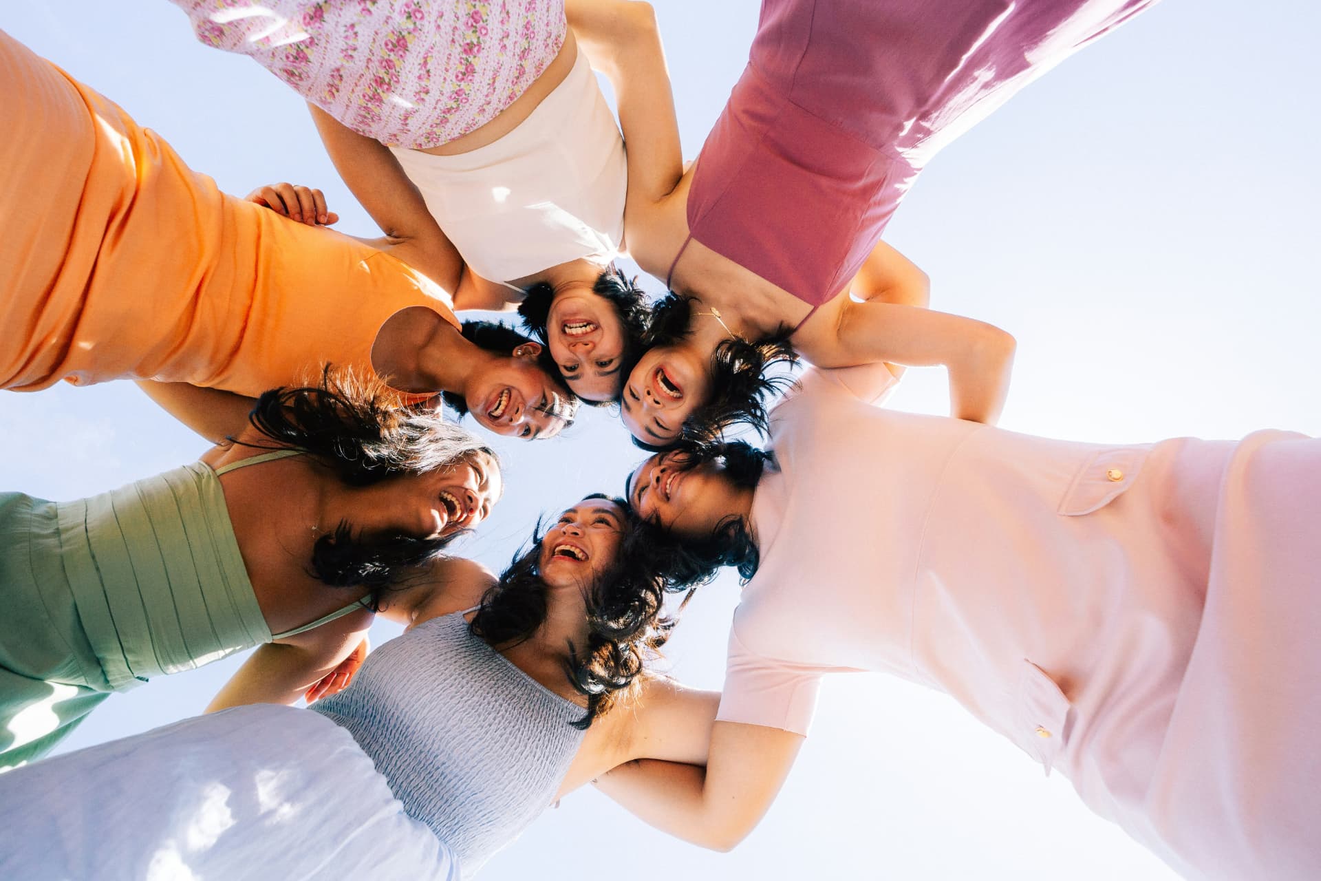 Group of friends laughing together, shot from below