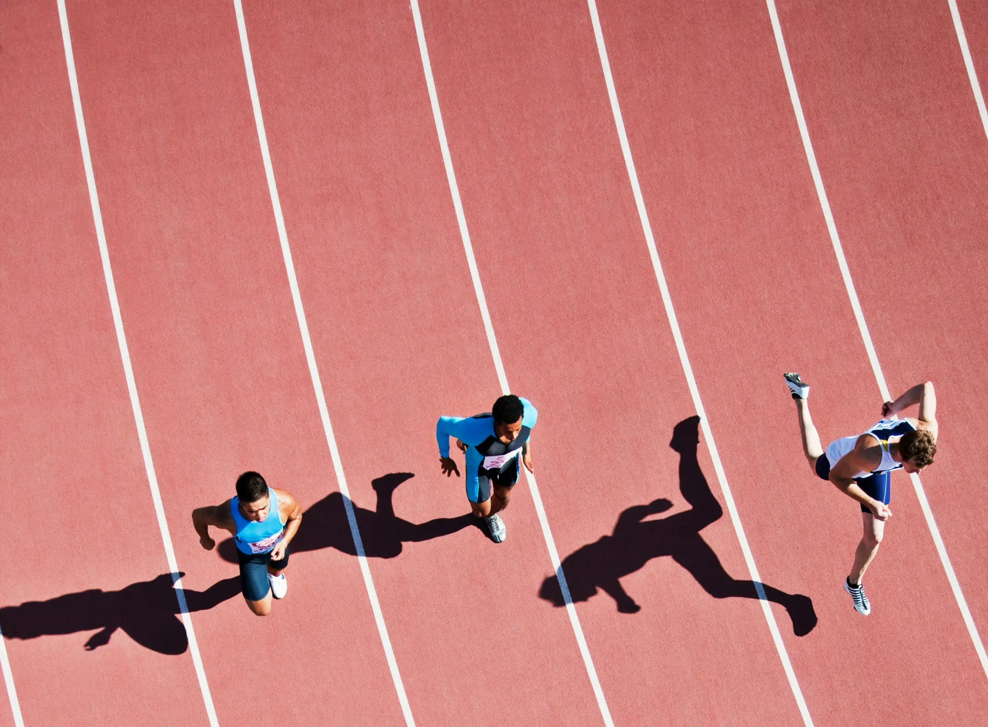 Sprinters racing on an athletics track, seen from above