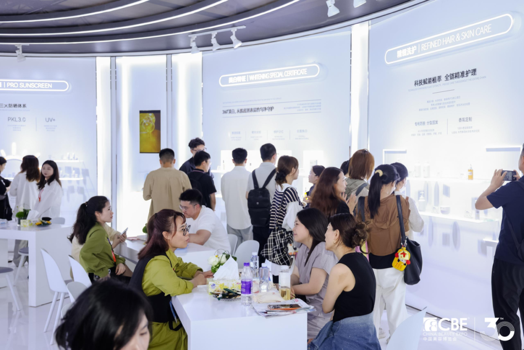 Visitors at a beauty brand stand at China Beauty Expo in Shanghai