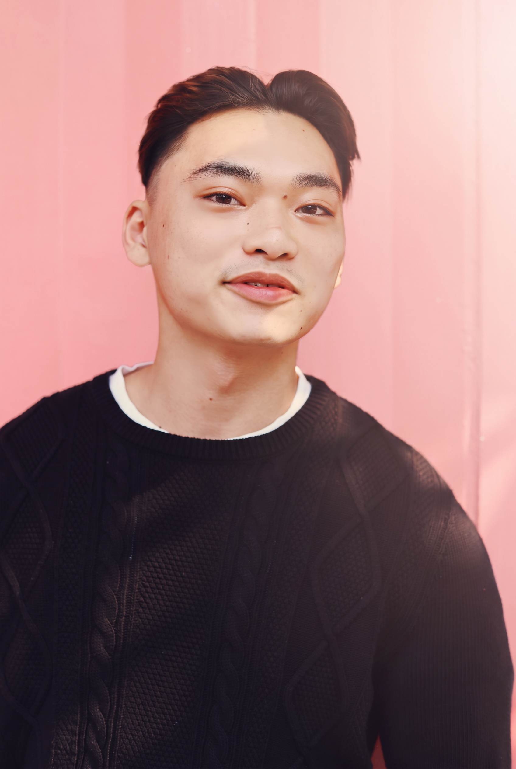 Portrait of a YASO team member against a pink backdrop