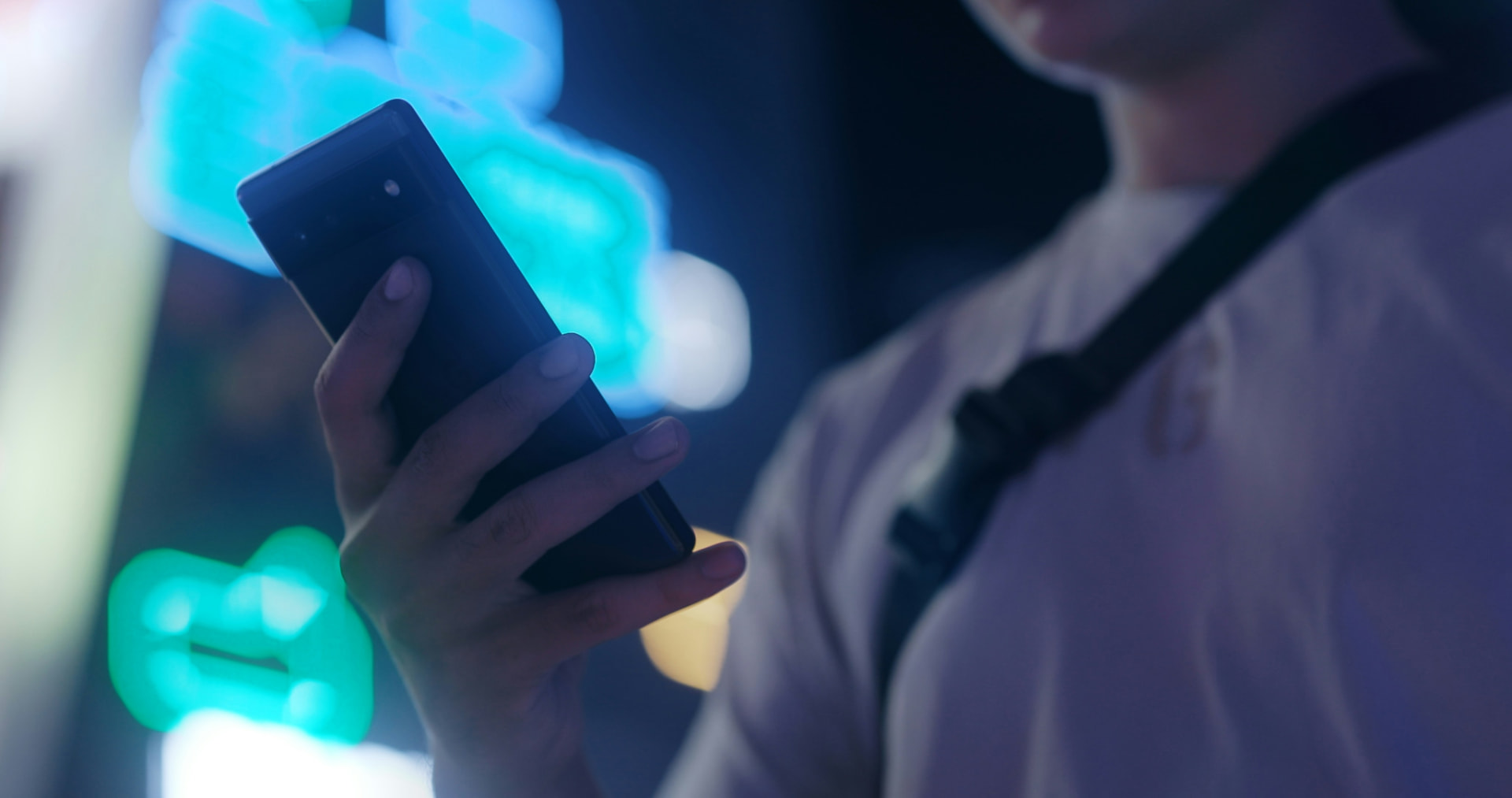 Close-up of a person holding a smartphone at night