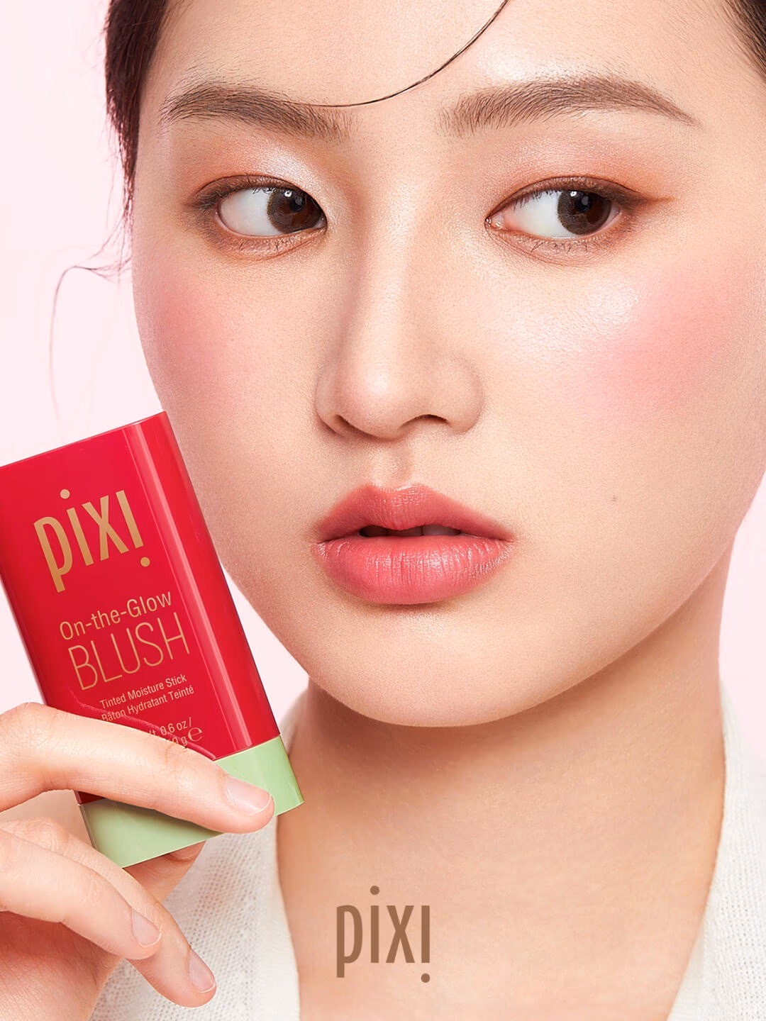 Pixi product hero shot with a model holding a Pixi compact.